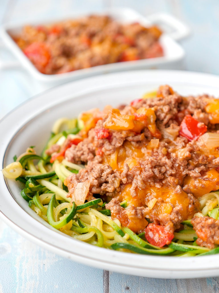  Spicy taco and zucchini noodles with minced meat, tomatoes and cheddar cheese 